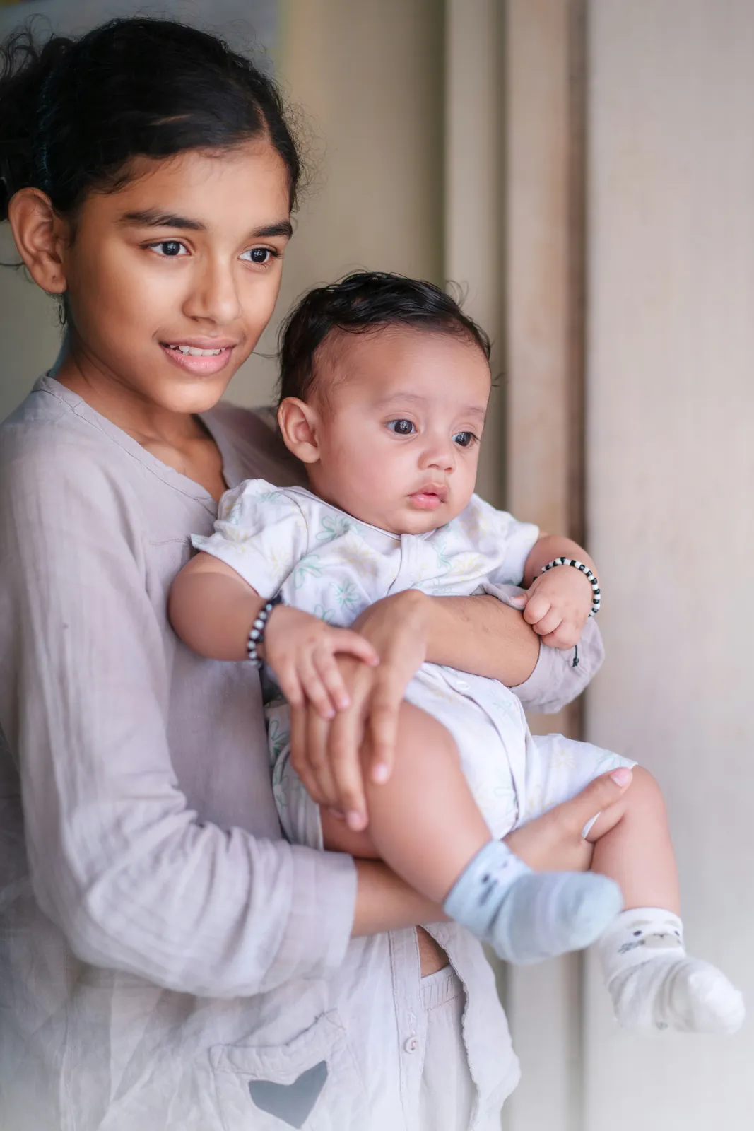 Child holding a baby